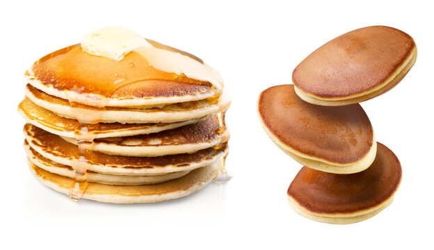 Stack of golden pancakes with melting butter and syrup beside floating dorayaki cakes isolated on a transparent background PNG