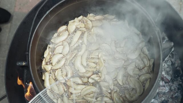 Deep Frying Fresh Potato Slices in Hot Cooking Oil