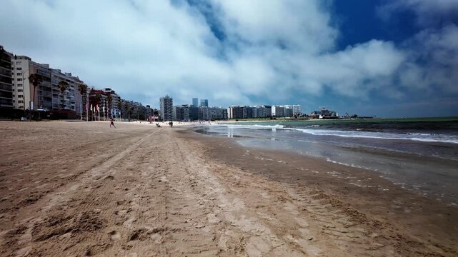 People walking on Playa de Pocitos beach, Montevideo, Uruguay