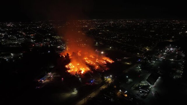Aerial Night View of Large Urban Fire with Heavy Smoke