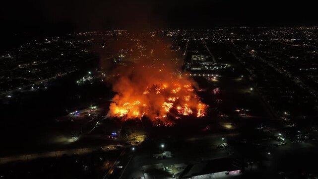 Aerial Night View of Large Urban Fire with Heavy Smoke