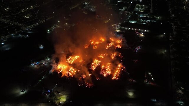 Aerial Night View of Large Urban Fire with Heavy Smoke
