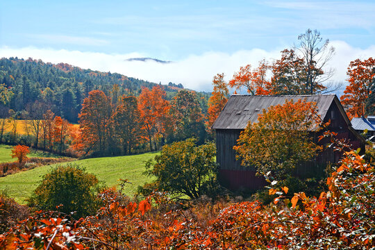 Autumn countryside with colorful fall leaves and rustic wooden barn, Vermont, USA
