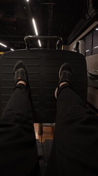 A close-up shot of a muscular male hand selecting a dumbbell from a rack in a dark, atmospheric gym. The image captures the essence of commitment and strength in fitness training.