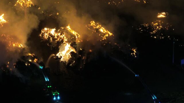 Aerial Night View of Large Urban Fire with Heavy Smoke