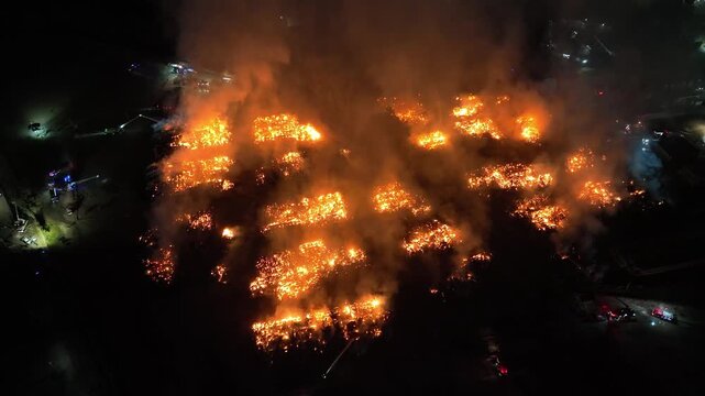 Aerial Night View of Large Urban Fire with Heavy Smoke