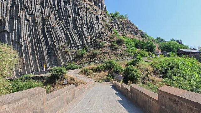 Walkway ascends toward striking hexagonal rock structures
