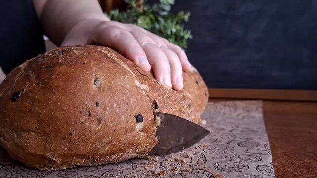 Slicing Rustic Walnut and Raisin Bread with a Knife