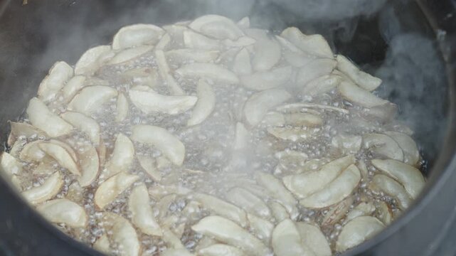 Deep Frying Fresh Potato Slices in Hot Cooking Oil