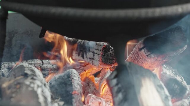 Close Up of Burning Firewood and Glowing Charcoal in Barbecue Grill
