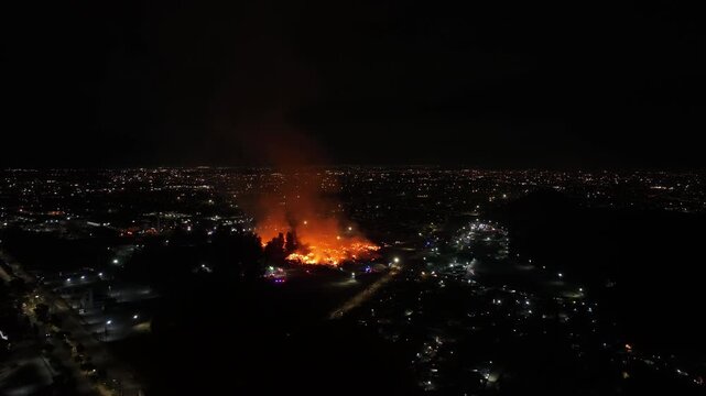 Aerial Night View of Large Urban Fire with Heavy Smoke