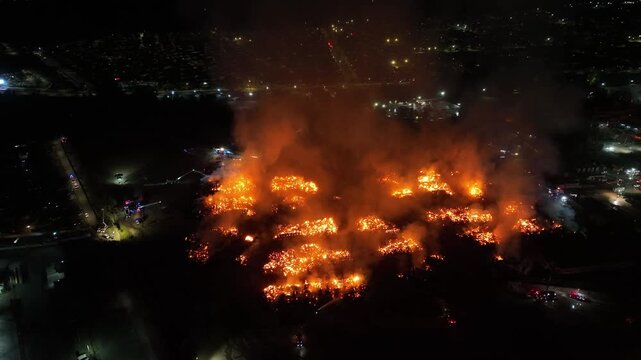 Aerial Night View of Large Urban Fire with Heavy Smoke