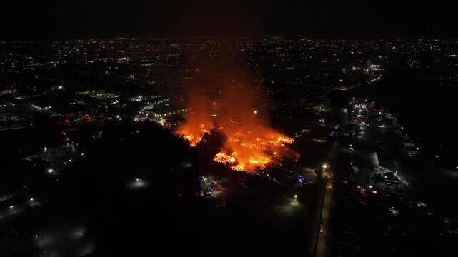 Aerial Night View of Large Urban Fire with Heavy Smoke