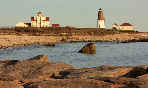 Afternoon view of Point Judith Lighthouse sitting on top of a hill next to the coast in Narragansett, Rhode Island