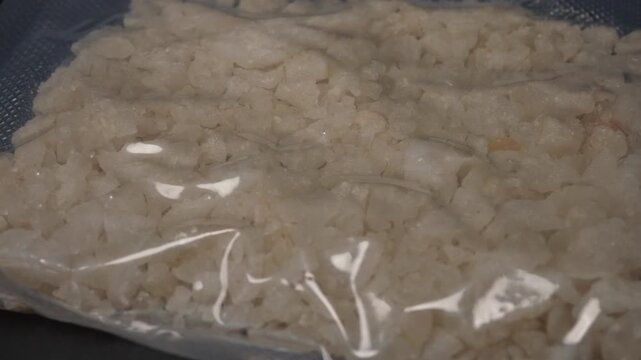 Fentanyl or meth is widely used stimulant in current drug trend. Methamphetamine mixed with fentanyl harms have increased in recent years. Illicit substance in plastic vacuum bag for transportation.