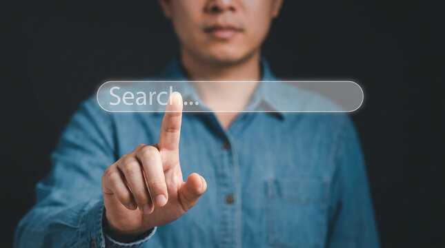 Search Input: A person's finger pointing to the search bar in a futuristic interface.