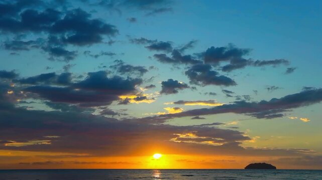 Spectacular sunset over the sea with aplm trees silhouettes in Malaysia