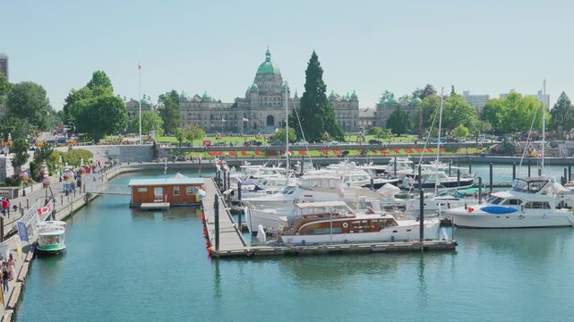 Victoria, BC, Canada - Aug 8, 2026: Victoria Inner Harbour marina with British Columbia Parliament Buildings background