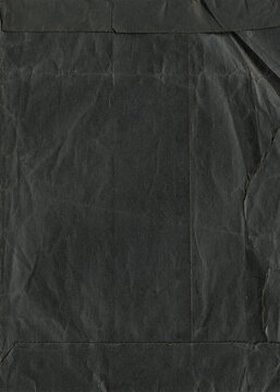 Old black envelope for photos. Recycled black paper for design. Black shabby aged photo editor layer. 