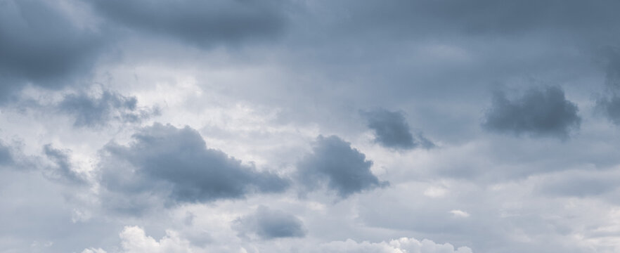 Overcast sky with thick gray clouds before rain, panoramic view of gloomy weather