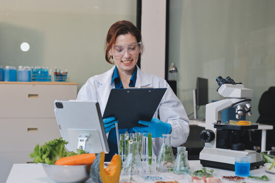 Scientists in lab coats work with plants in a modern lab, focusing on research and experimentation under bright, sterile conditions.