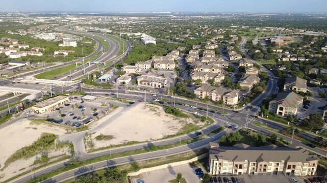 State Highway 151 interchange intersects Culebra Road arterial near busy retail strip centers. Panoramic shot captures regional transit connectivity across Westover Hills, San Antonio, TX
