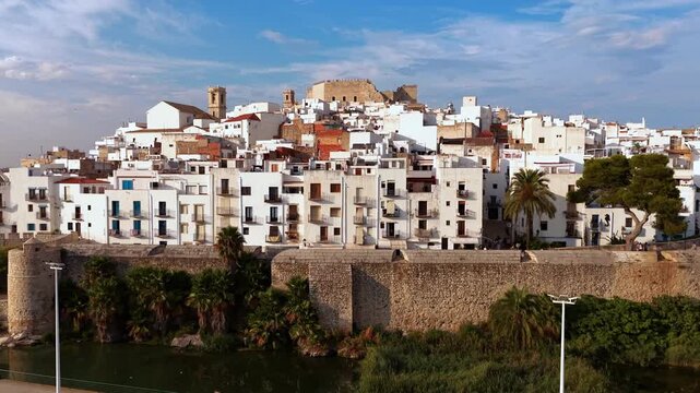 Aerial tilt view of Peniscola old town white houses and castle in Valencian region, Spain. High quality 4k footage