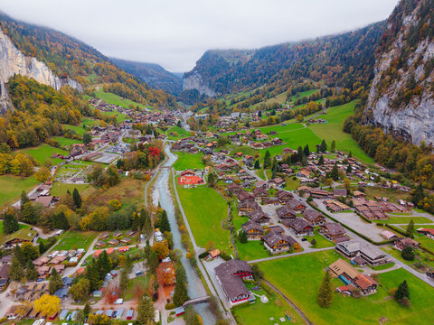 Lauterbrunnen valley autumn landscape aerial view with Staubbach Falls, village and train station. Lauterbrunnen, Canton of Bern, Switzerland.
