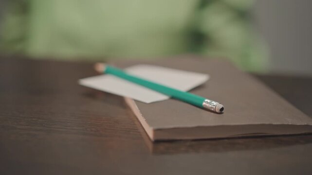 Musician creates song through drawing. Artist designs melodies using pen and paper. Creative songwriter crafts melodies and lyrics using traditional drawing instruments and writing materials