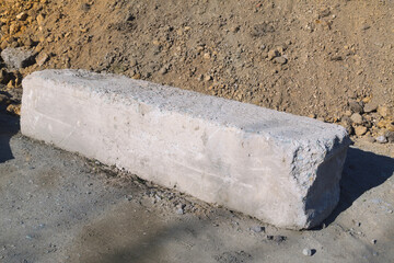 Fototapeta premium Exposed Concrete Block Amid Dirt