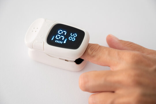 Pulse oximeter measuring blood oxygen saturation on finger
