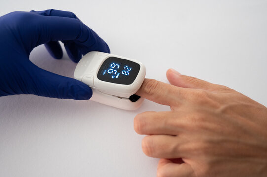 Doctor checking patient oxygen saturation with pulse oximeter