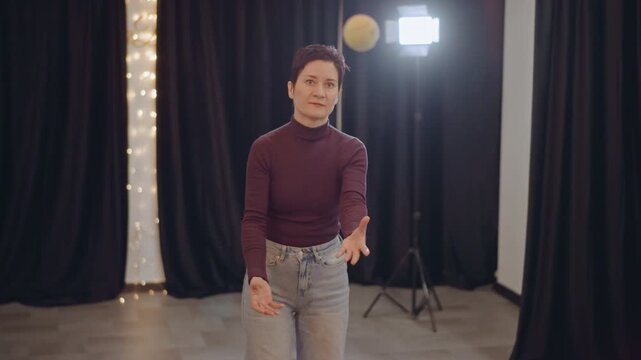 Studio floor asian movement coach practices ball rhythm and posture drills, soft box light and black curtains, solo training focused on balance and timing, deliberate slow motions and breath control.
