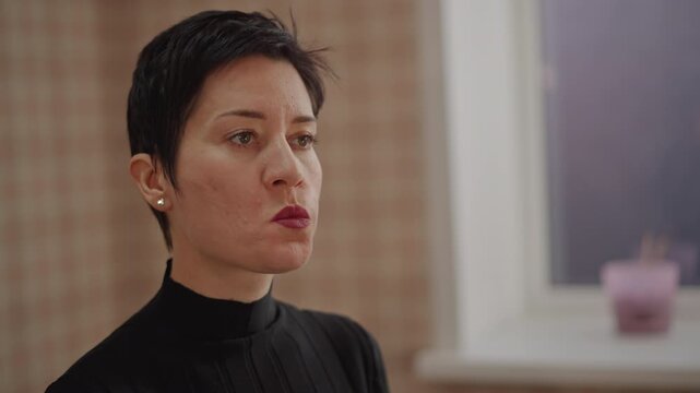 Short hair singer practicing articulation exercises with focused lip shaping and vowel work, closeup portrait with warm indoor light, instructor guided diction session, concentrated expression