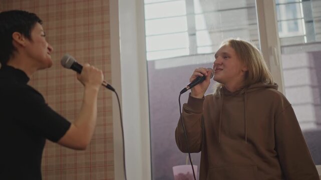 Call and response duet practice near window light with two singers exchanging phrases, close mic work, breathing drills, improvised harmonies, rapport building and audition preparation