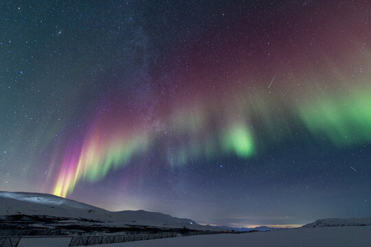Green Aurora over a Snowy Arctic Landscape
