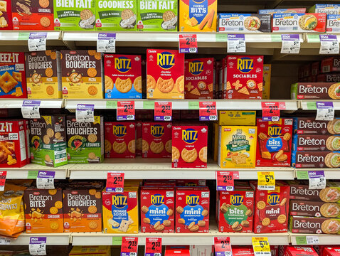 Gaspesie, Quebec, 11 July 2026 : Ritz, Breton, and Cheez-It crackers are stocked on multiple shelves in a grocery store aisle.