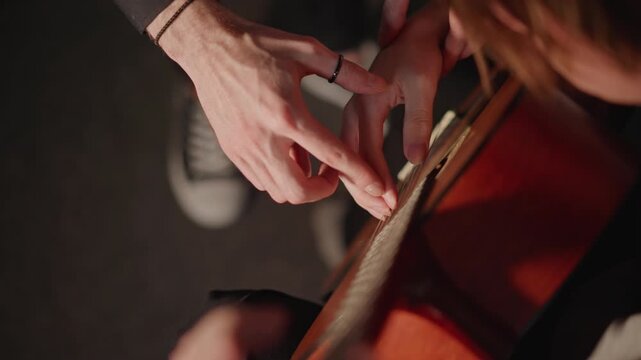 Instructors improve skills. Guide students in hand placement. Teacher demonstrates proper fingering techniques clearly. Mentor provides encouragement and support during practice sessions regularly