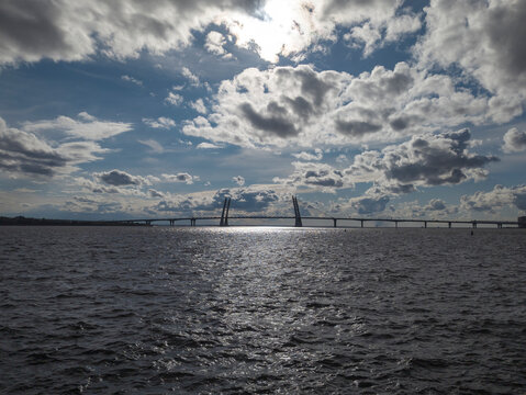 Cable-stayed bridge over the sea at sunset with dramatic cloudy sky, St. Petersburg, Russia