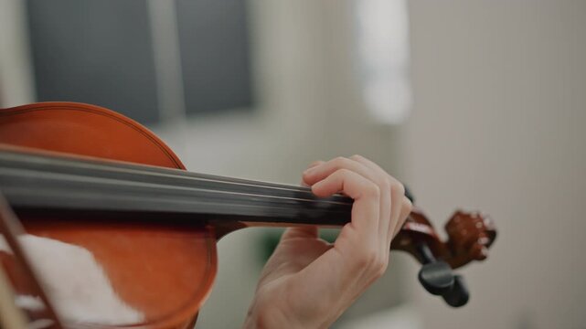 Violin finger positions. Accurate string finger placement demonstration. Closeup view of precise violin finger movements. Demonstration of exact violin finger positioning with close detail view