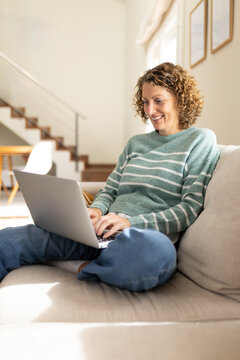 Woman smiling using laptop working from home remote