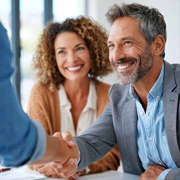 Business meeting takes place in office with handshake between two people
