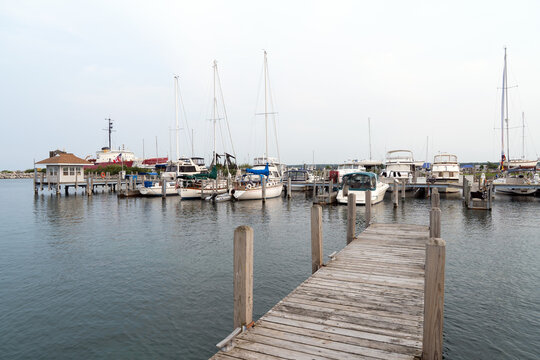 Serene marina featuring sailboats and yachts docked beside a waterfront pier with calm water at Petoskey, Michigan