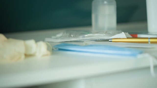 Medical supplies prepared. Hospital equipment including mask sanitizer and pen neatly set up. Restockready medical tools such as mask sanitizer and pen placed on white surface with clinical lighting