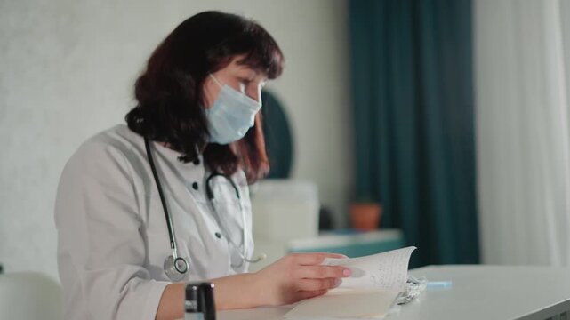 Healthcare specialist carefully inspects admission documents during consultation. Healthcare provider meticulously verifies patient documentation in quiet setting with stethoscope nearby