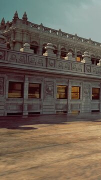 A large building stands with intricate stonework on the walls. Sunlight shines on the structure, highlighting the large windows. The environment appears bright and warm.