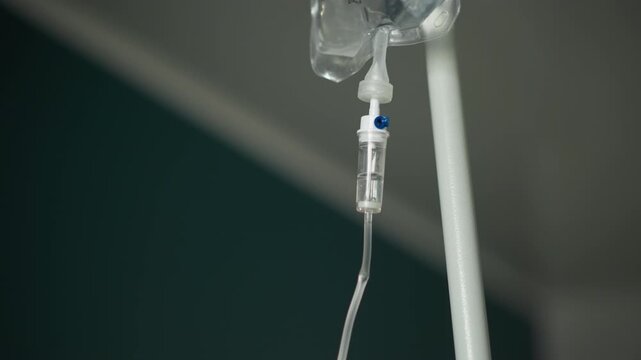 Saline infusion setup. Medical intravenous drip and equipment. Hospital scene with saline drip and medical tools. Patient care environment featuring intravenous fluids and clinical apparatus