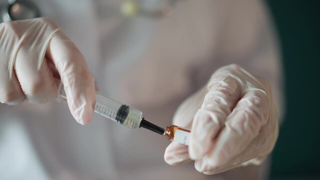 Nurse administering injection. Precise syringe filling procedure. Nurse carefully draws medication into syringe. Healthcare professional precisely measures medication dosage in clinic setting