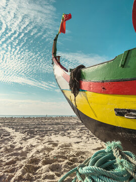 Traditional Portuguese fishing boat on sandy beach