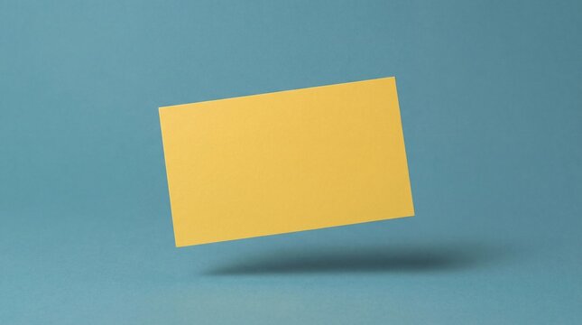 A blank yellow card floats in the air against a solid blue background, casting a subtle shadow below.